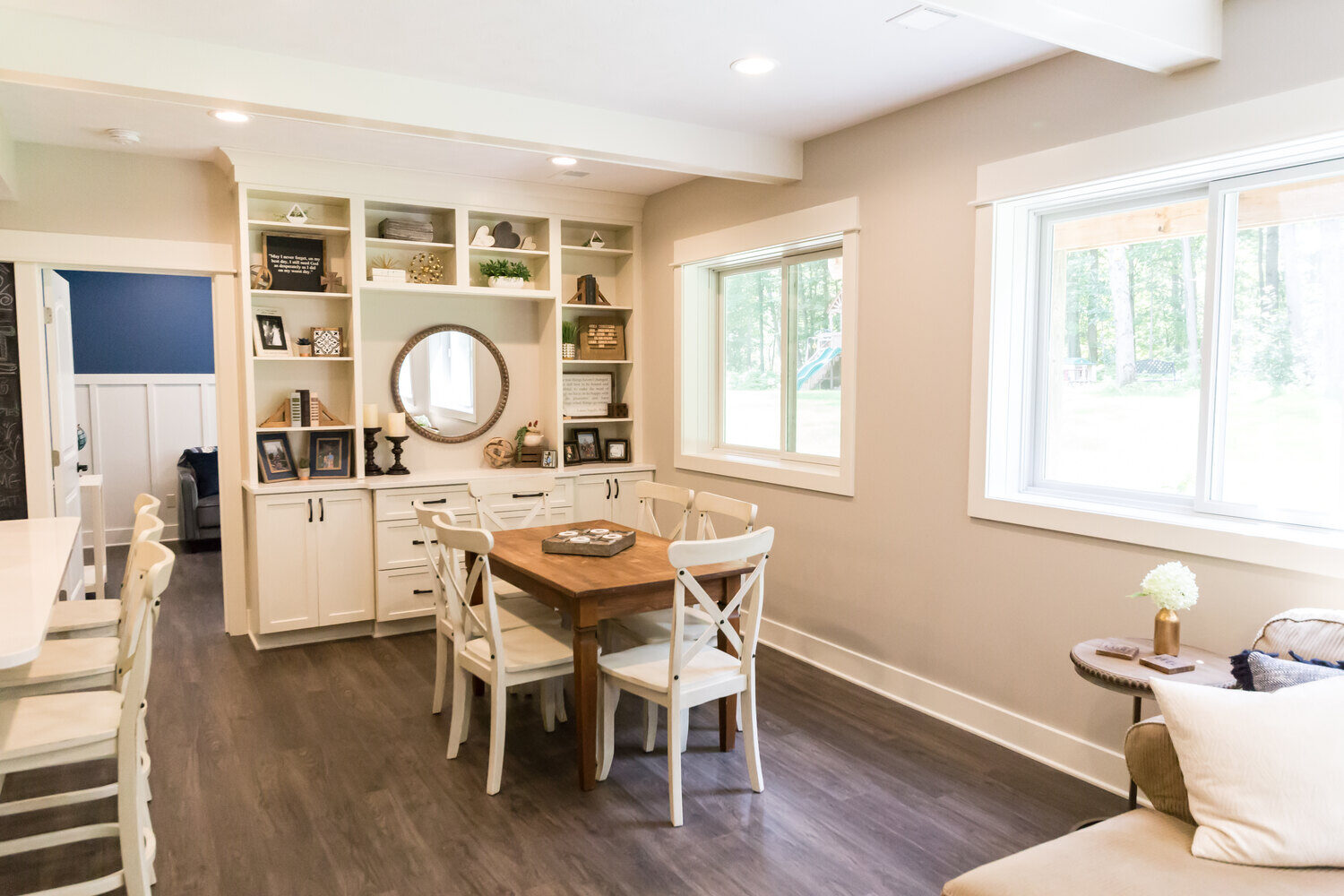 Basement dining area with built-in shelves and wood table remodeled by Ridgewood Home Construction in Grand Rapids