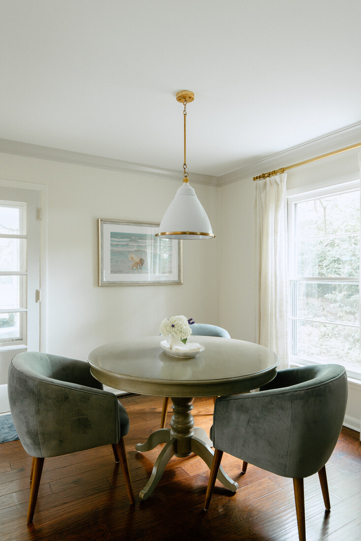 Bright breakfast nook with round table and modern light fixture in Grand Rapids remodel by Ridgewood Home Construction