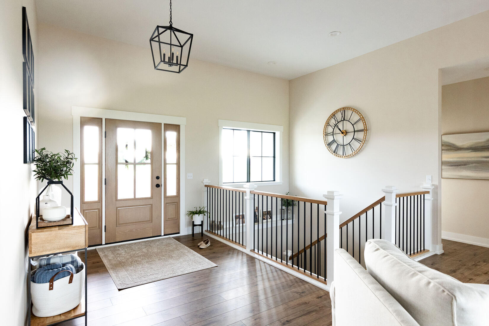 Entryway with wood double doors and staircase railing in West Michigan main floor remodel by Ridgewood Home Construction Entryway with wood double doors and staircase railing in West Michigan main floor remodel by Ridgewood Home Construction
