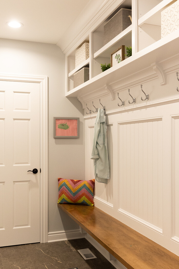 Functional basement mudroom with storage cubbies and wall hooks by Ridgewood Home Construction in Grand Rapids Township