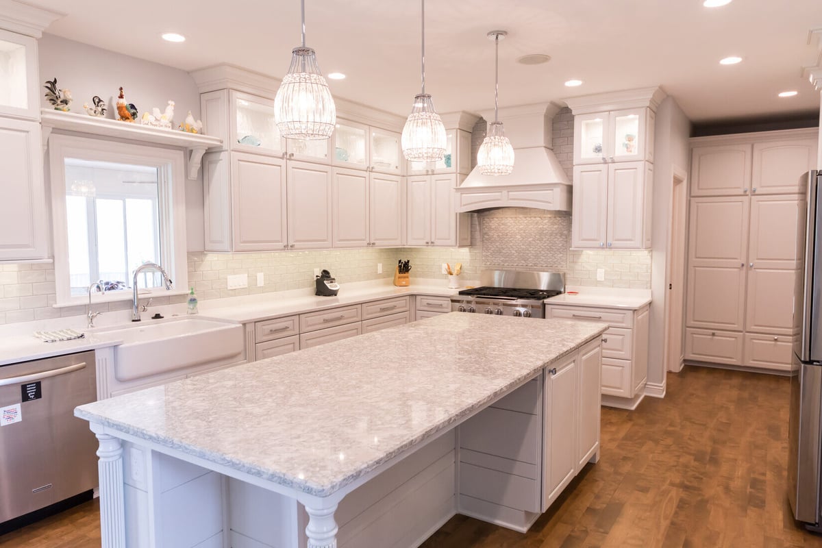 Full kitchen view with oversized island and pendant lighting by Ridgewood Home Construction in Grand Rapids Township
