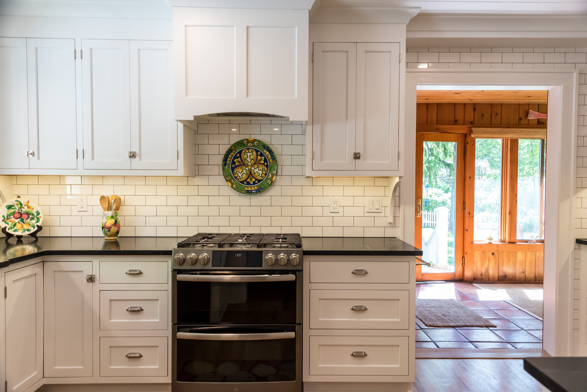 White cabinetry and gas range setup in Rockford, MI kitchen remodel by Ridgewood Home Construction