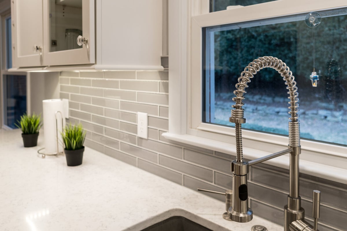 Close-up of spring pull-down faucet in Rockford, MI kitchen remodel by Ridgewood Home Construction