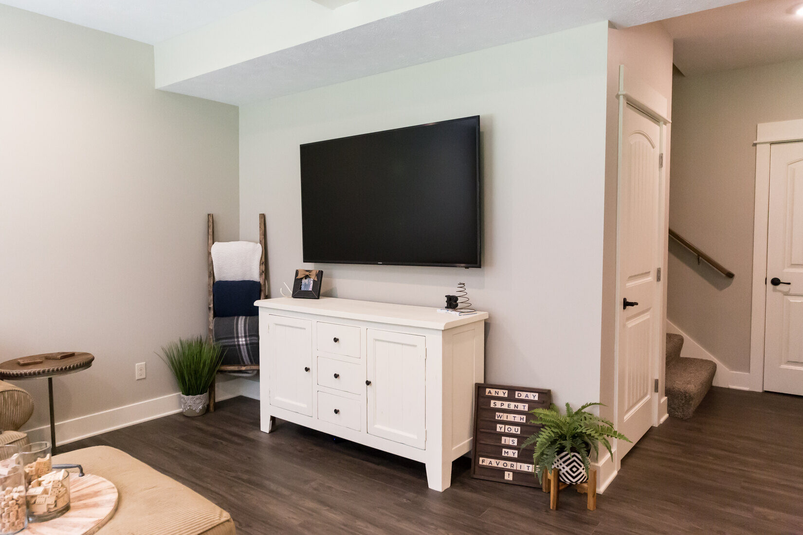 Basement media room with mounted TV and storage cabinet in Sparta, MI by Ridgewood Home Construction Basement media room with mounted TV and storage cabinet in Sparta, MI by Ridgewood Home Construction