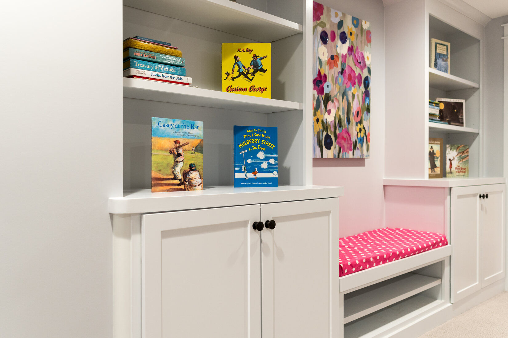 Childrens reading nook with built-in bookshelves and bench in Ridgewood Home Construction’s Grand Rapids basement