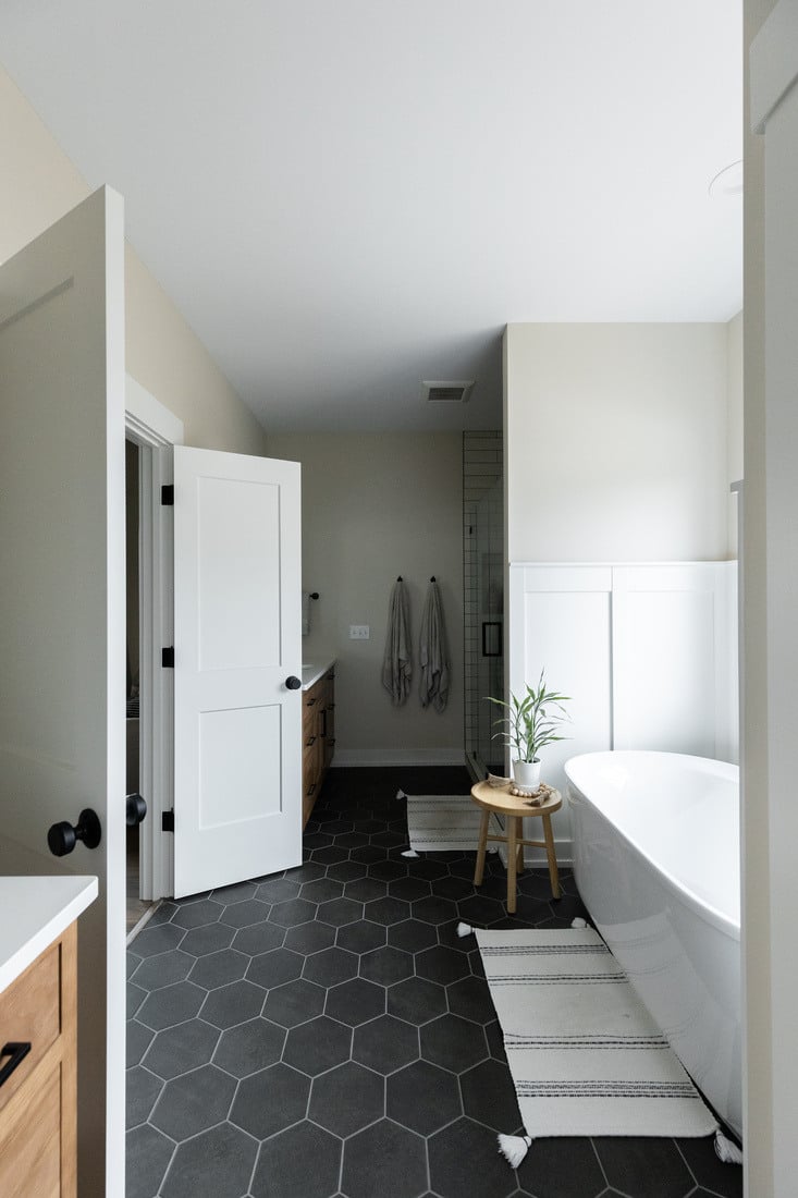 Bathroom entrance with freestanding tub and hex tile floor in West Michigan main floor remodel by Ridgewood Home Construction