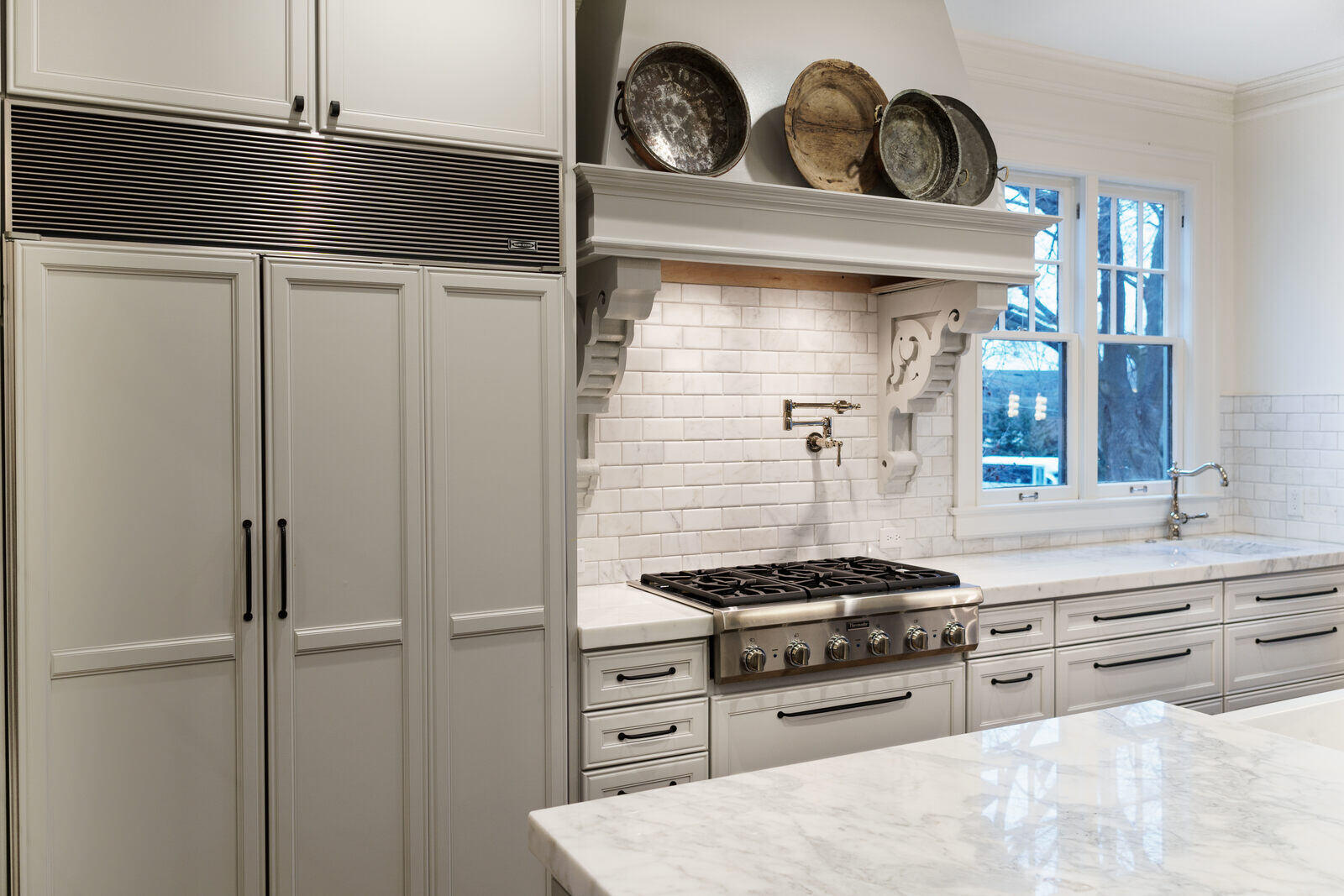 East Grand Rapids kitchen remodel with classic white cabinetry and subway tile by Ridgewood Home Construction