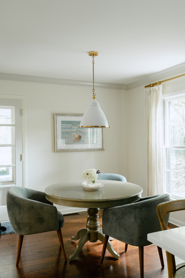 Breakfast nook with round dining table and pendant light in East Grand Rapids remodel by Ridgewood Home Construction