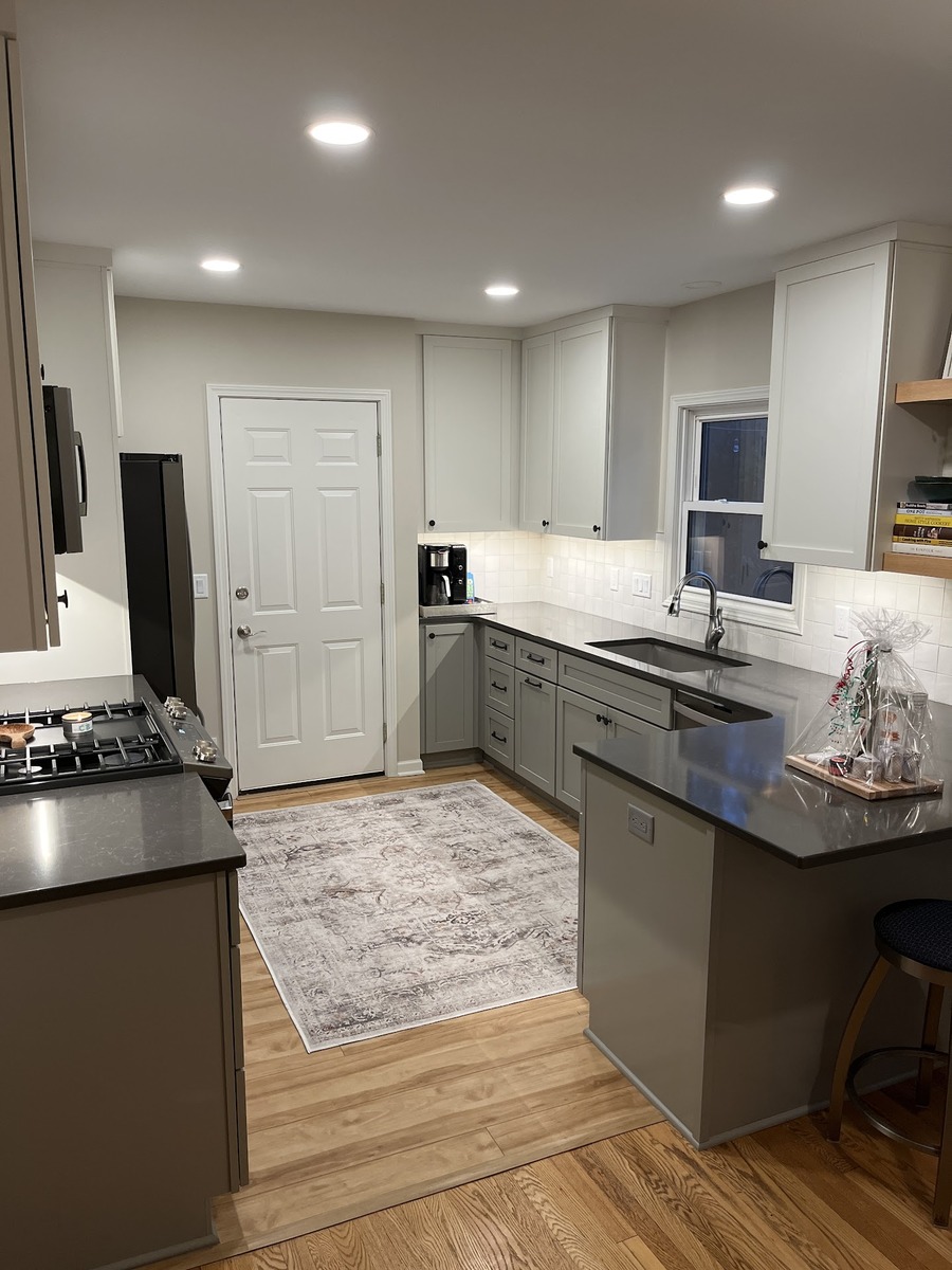 Modern kitchen remodel with gray cabinetry and quartz countertops by Ridgewood Home Construction in Grand Rapids