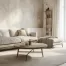 A modern living room in West Michigan, with a light-colored sofa, round coffee table, side table with a vase, floor lamp, and large windows with sheer curtains letting in natural light for a fresh, refreshing atmosphere.